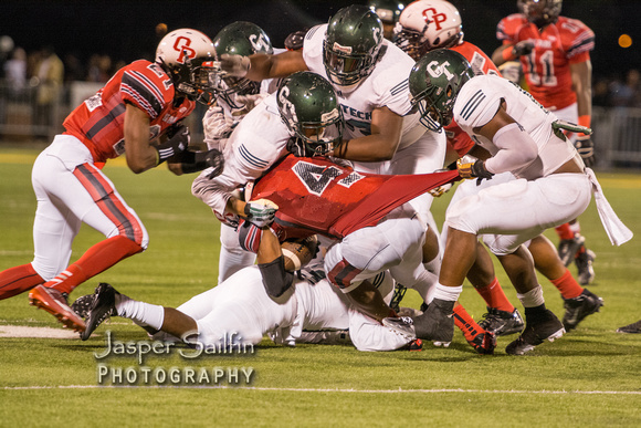 Oak Park RB John Kelly is tackled by a host of Technicians